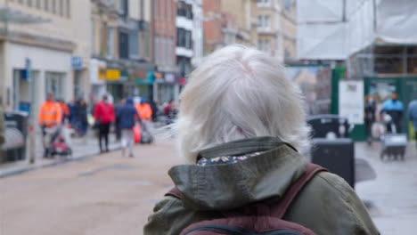 Tracking-Shot-Following-Senior-Woman-Walking-Down-Street